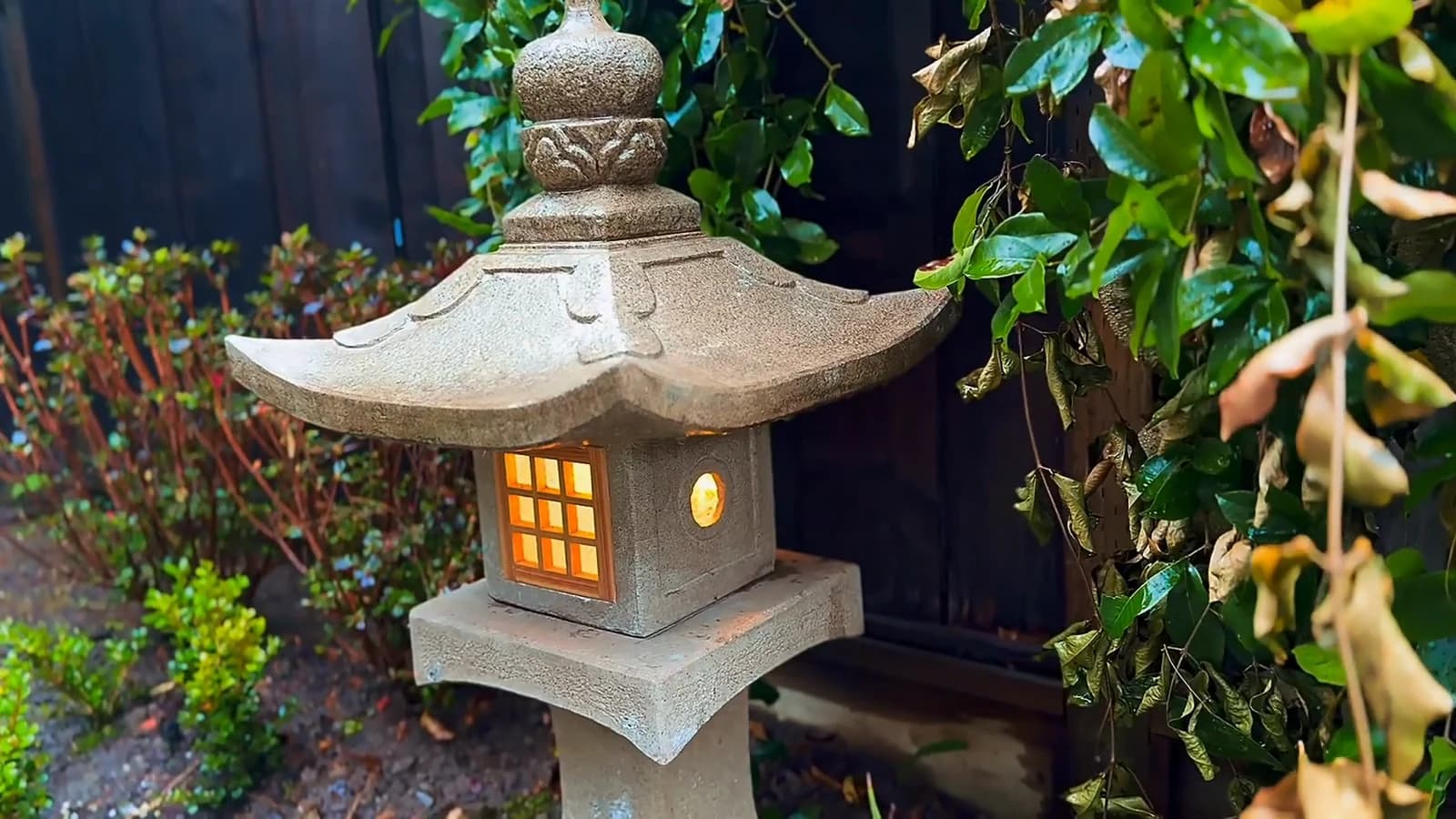 Detail of a stone lantern with a warm illuminated opening