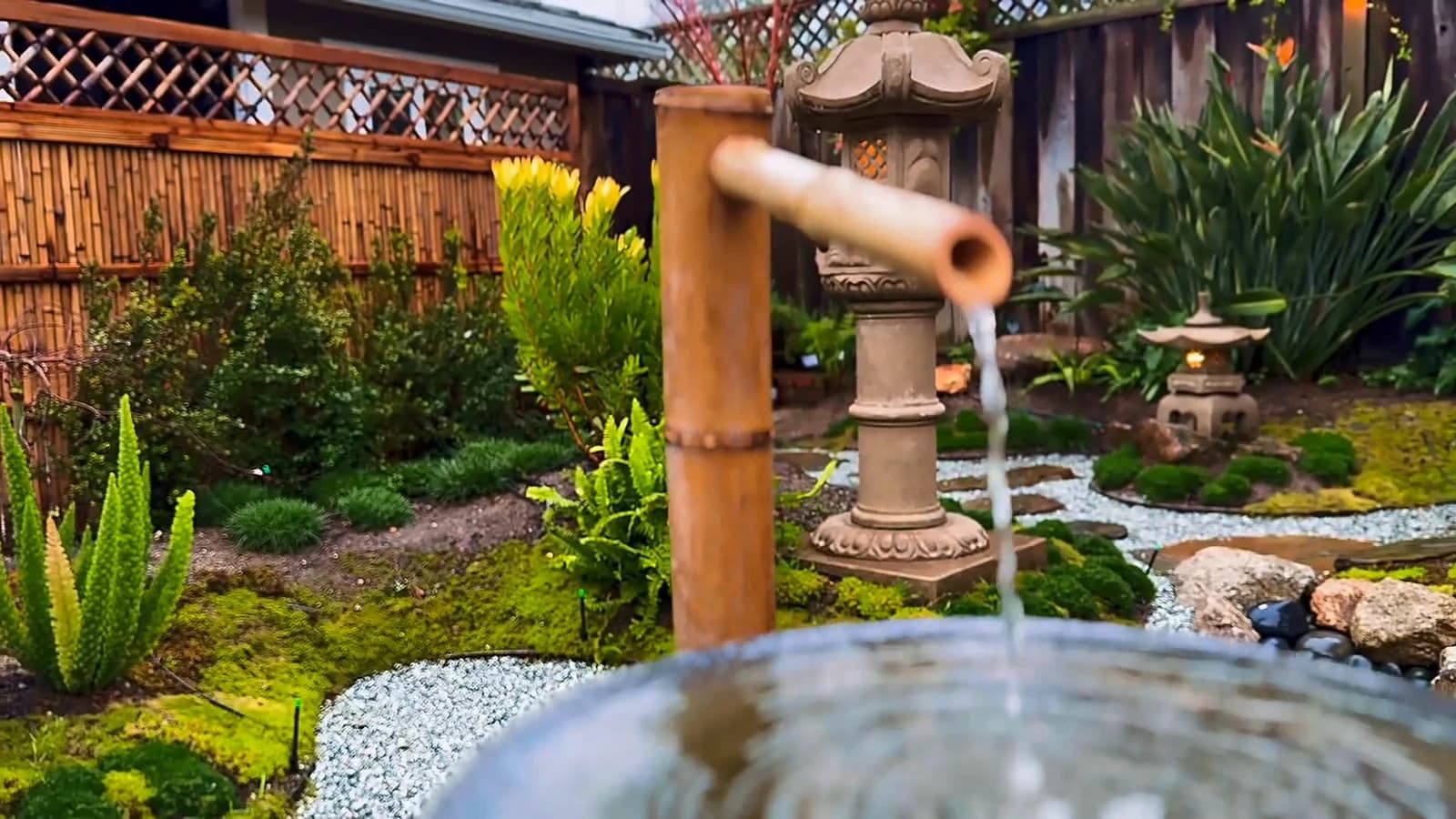 Bamboo spout pouring water into the garden basin
